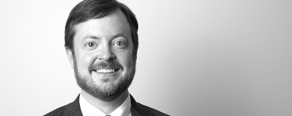 Black and white headshot of Jason Burge